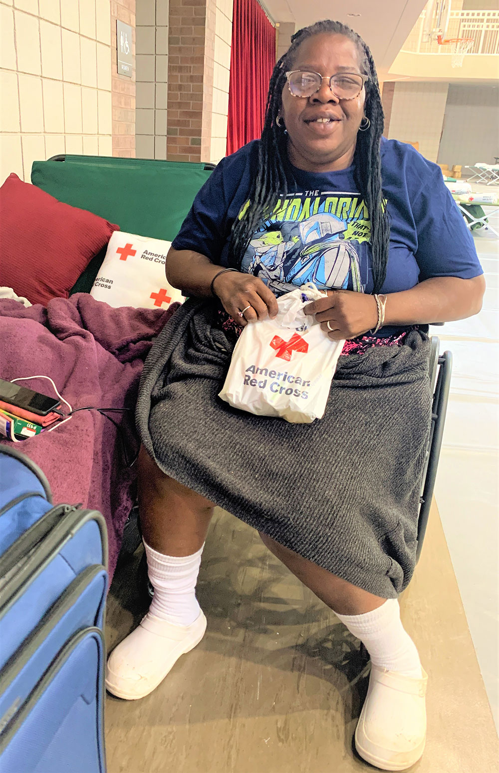 Yolanda Crater smiling and holding red cross bag