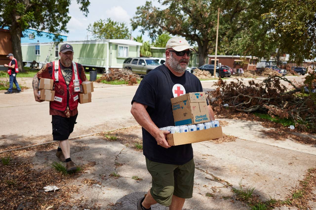 July 20, 2024. Clute, Texas.
Red Cross volunteer Keith Garcia and Andrew Barker goes door-to-door in the Pecan Forest Mobile Home Community in Clute, Texas, distributing shelf-stable milk, generously donated by Chobani, and cans of water, generously donated by Anhesuer-Busch, to families who lost power for more than a week following Hurricane Beryl.
Photo by Jaka Vinsek/American Red Cross