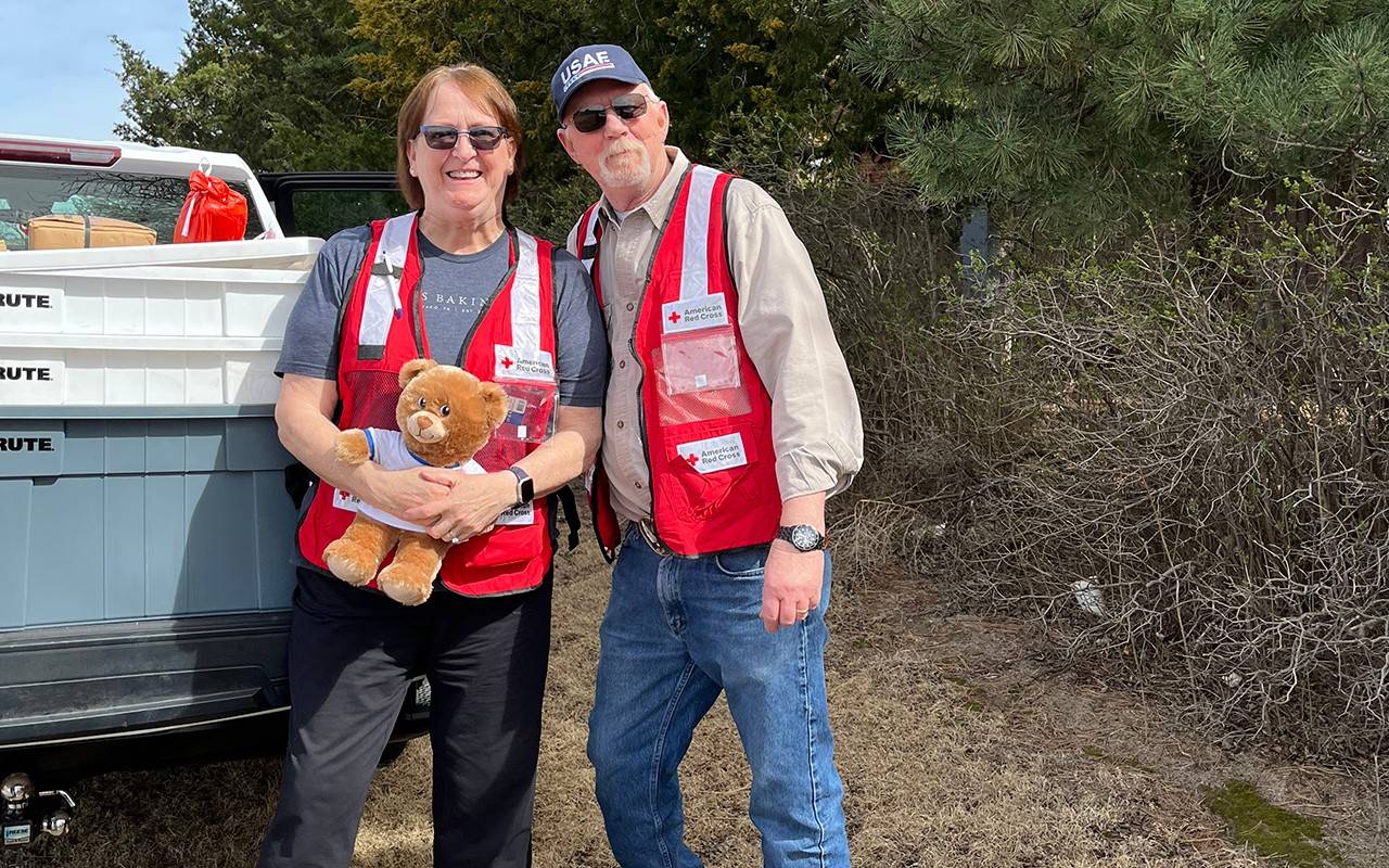 Volunteers hand out stuffed teddy bears