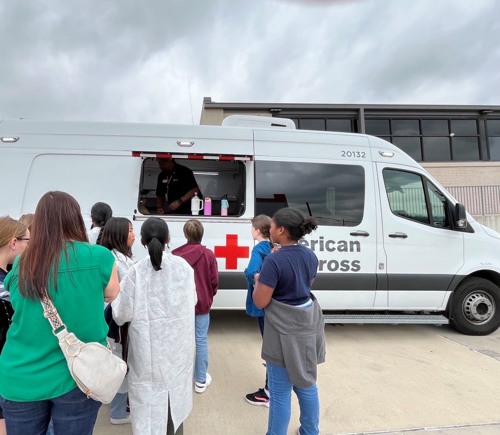 wylie students outside in front of red cross vehicle