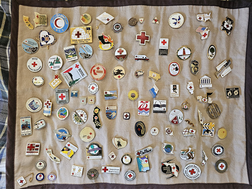 Several Red Cross pins on cloth