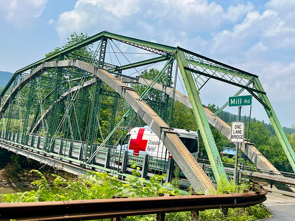  Red Cross Disaster Relief van driving on a bridge.