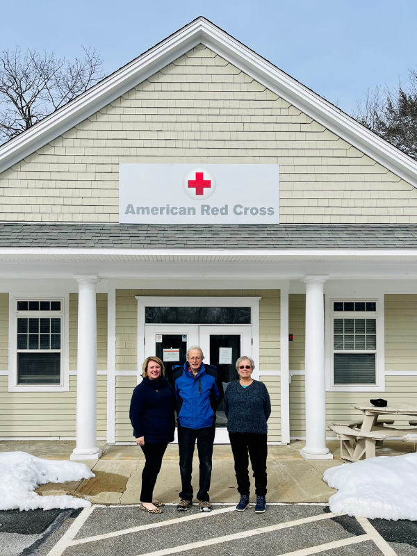 sophie, fred, and lorraine stand in front of red cross office