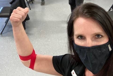 lacie wearing a mask arm up after blood donation