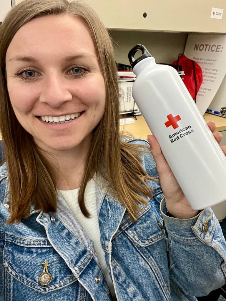 Dana Maze holding up Red Cross reusable water bottle.