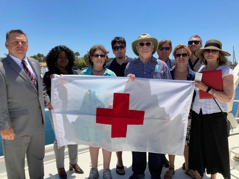 Family holds Red Cross flag