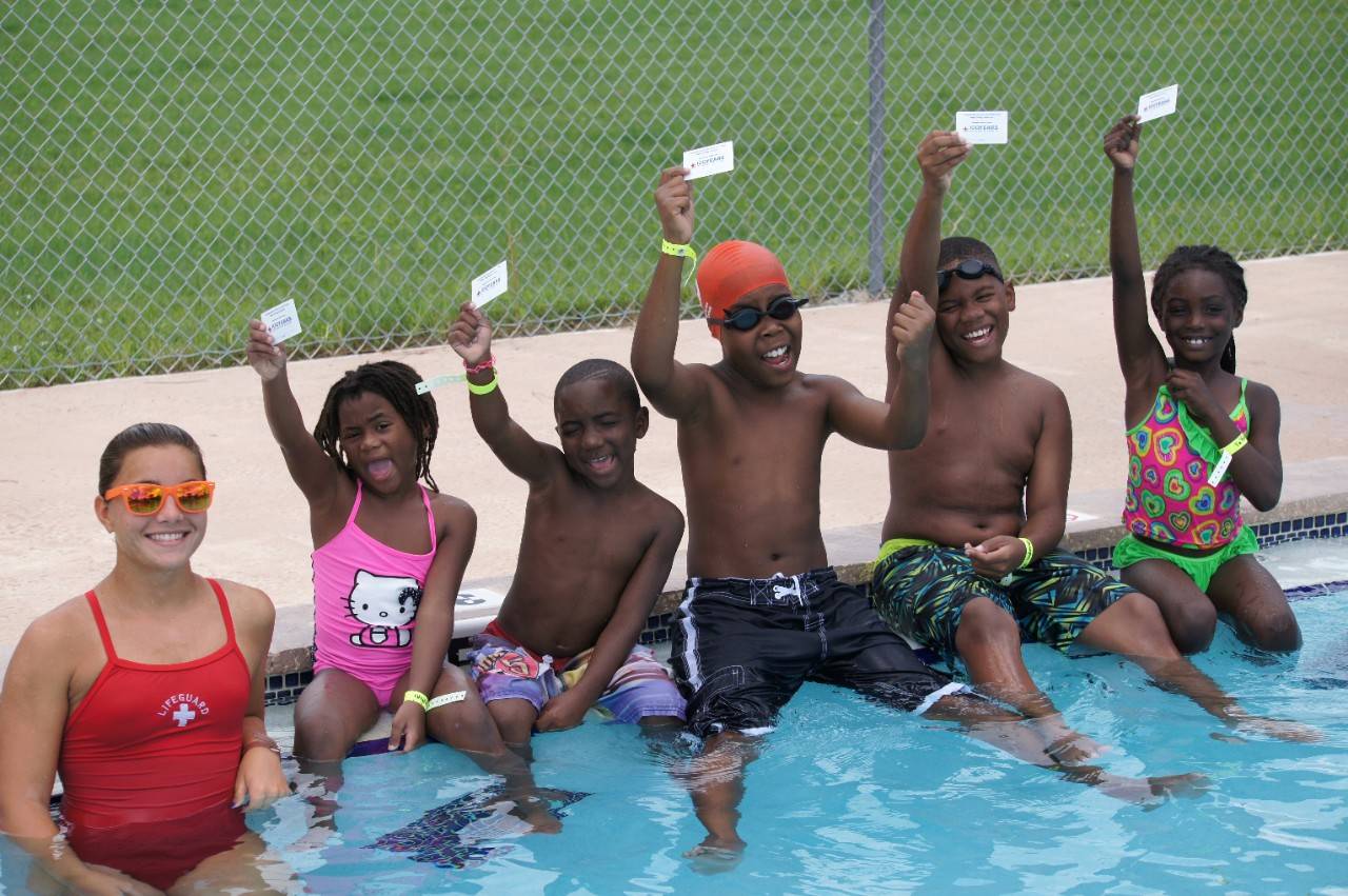 August 7, 2014. Brevard County, Florida. Children proudly show their Learn-to-Swim completion cards that they achieved by participating in swim lessons as part of the Aquatics Centennial Campaign. Photo by Connie Harvey/American Red Cross