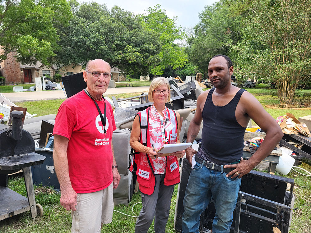 Paul Henke, Suzanne Pehl and Charles Campbell Jr. outside next to damaged property on lawn