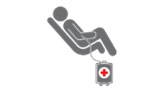 Icon of person sitting in cot donating blood.