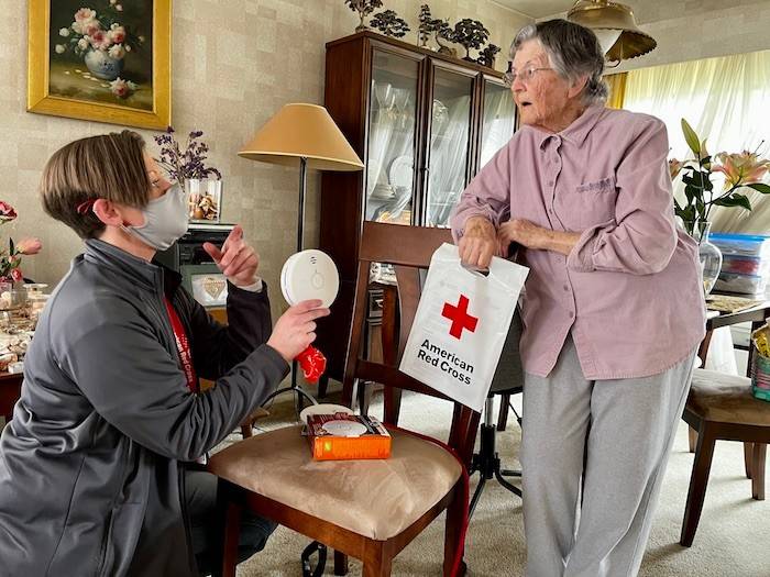 red cross volunteer talking with client