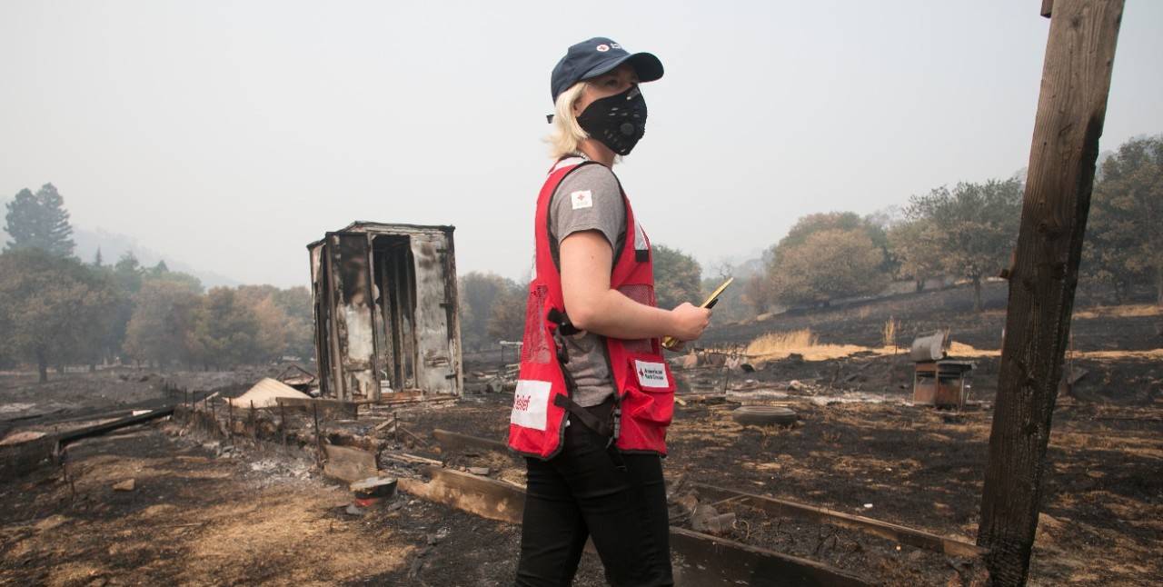 August 24, 2020. Vacaville, California.
LNU Complex Fire burn zone on Pleasants Valley Road in Vacaville, California. Red Cross volunteer Jillian Robertson surveys a property charred by the wildfire.
Photos by Dennis Drenner/American Red Cross