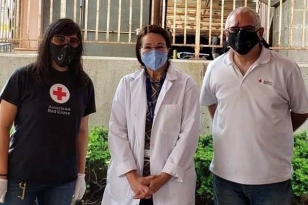 Dr. Angeleke Saridakis standing in the middle next to Red Cross Volunteers.