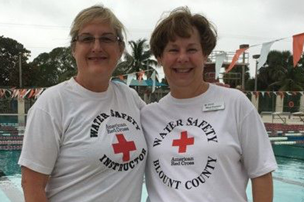 Mary Franklin standing next to a water safety instructor at a pool.