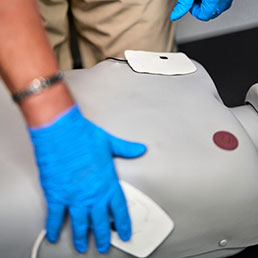 Student placing AED pads on an Elevate SMART CPR Manikin.