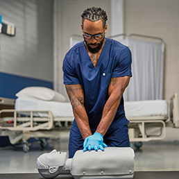 Healthcare professional practicing CPR with the Elevate™ SMART Manikin.