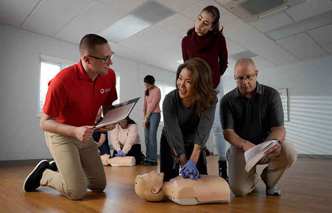 Red Cross Instructor teaching CPR training to students.