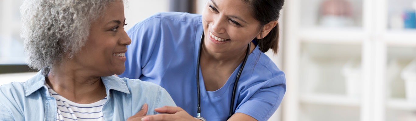 Certified nursing assistant (CNA) helping a patient.