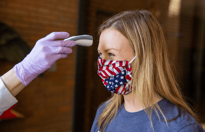 Woman getting her temperature taken