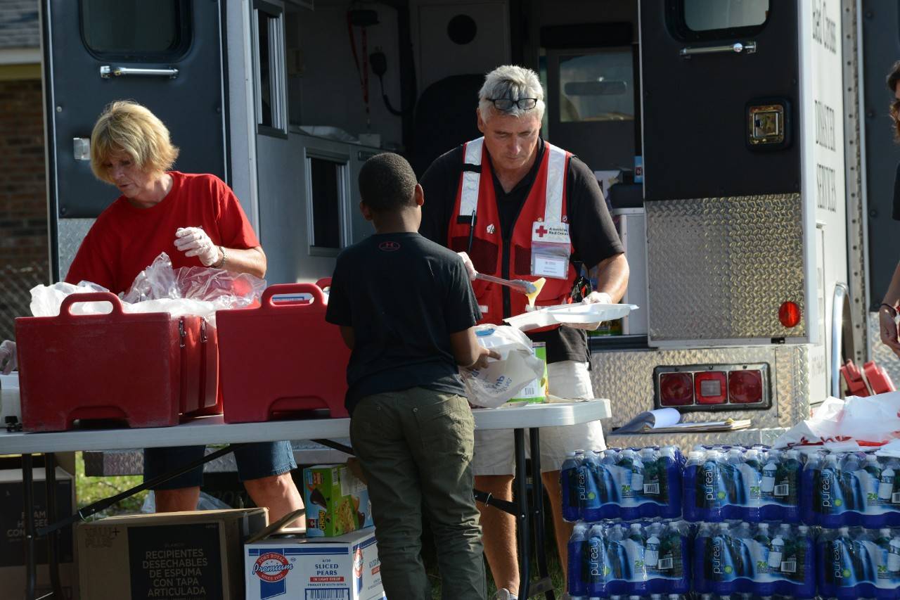 Friday October 14, 2016. Lumberton, North Carolina
Steve Havens and Jan Unger of Michigan, and Tom Jacobs and Anne Johnson of Flagstaff, Arizona, were tired after a long week of supporting Hurricane Matthew, but very proud of the long trip that they had made out to North Carolina, driving Red Cross Emergency Response vehicles.  They were very happy to finally have access to the Lumberton community, which had been rendered inaccessible by flood waters, and be able to bring hot food and warm smiles to the members of this community who suffered so much this week.
Photo by Daniel Cima for the American Red Cross, Hurricane Matthew Response