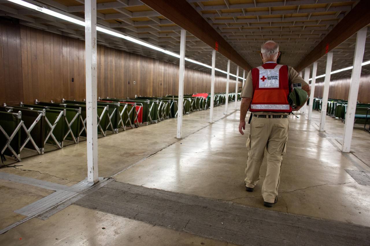 February 15, 2017. Chico, California.
Red Cross worker, Sam, cleans and organizes cots in the Silver Dollar Fairgrounds where he is a shelter manager.
Sam is joining Oroville Dam evacuation efforts from Los Angeles. He has been a Red Cross volunteer since Hurricane Katrina.
Photo by Marko Kokic for the American Red Cross, Oroville Evacuations to Red Cross Shelters