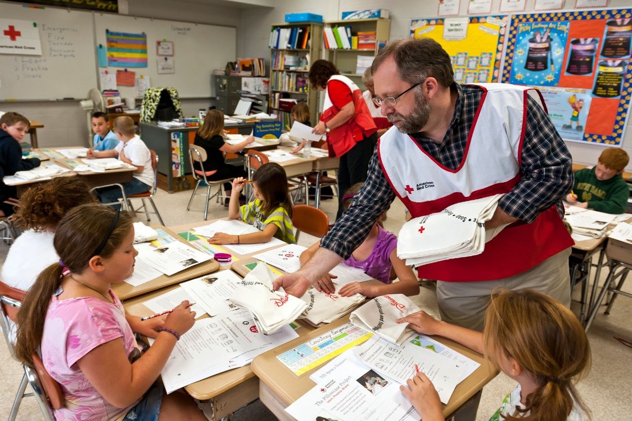 volunteers in classroom with children