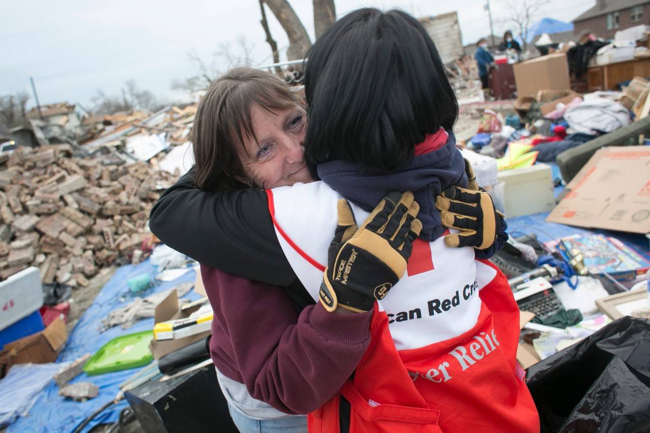 January 2, 2016 -- Garland, Texas -- ERV crews take donated meals from an area Chilis Restaurant to areas of Garland and Rowlett affected by the recent tornadoes.
ERV team member Roxanne Bunkoff hugs Cathrine Armstrong, who was sorting through the rubble of her home in Rowlett.
Photos by Dennis Drenner for the American Red Cross., Red Cross worker Roxanne Bunkoff comforts Catherine Armstrong as she sorts through rubble that once was her home in Rowlett, Texas. (Red Cross photo by Dennis Drenner.)