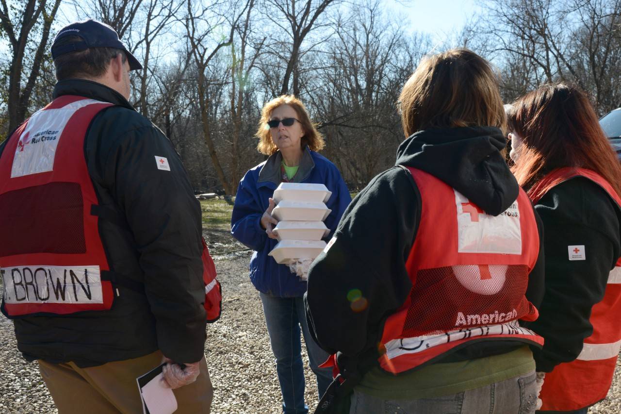 Flood survivor Marcia Walsh welcomes hot meals from James Brown; Sherri Brown and Devyn Brown -- a Red Cross volunteer family based in Missouri. Valley Park; Missouri. January 3; 2016.
Photo by Daniel Cima for the American Red Cross, Red Cross Volunteers Help Flooding and Tornado Victims Across Multiple States