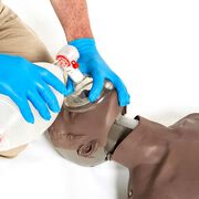 Student using a bag valve mask on the Brayden/OBI Adult CPR Manikin with LED Red Light CPR Feedback, Brown.